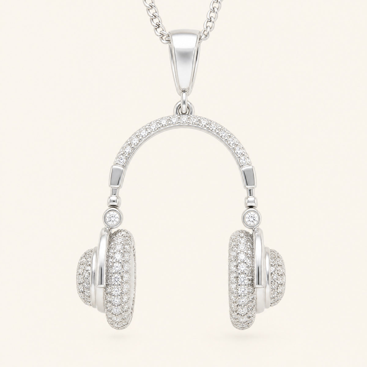 Pavé headphone pendant, front view: large polished bail, pavé headband, a round stone at each hinge, pavé ear cups