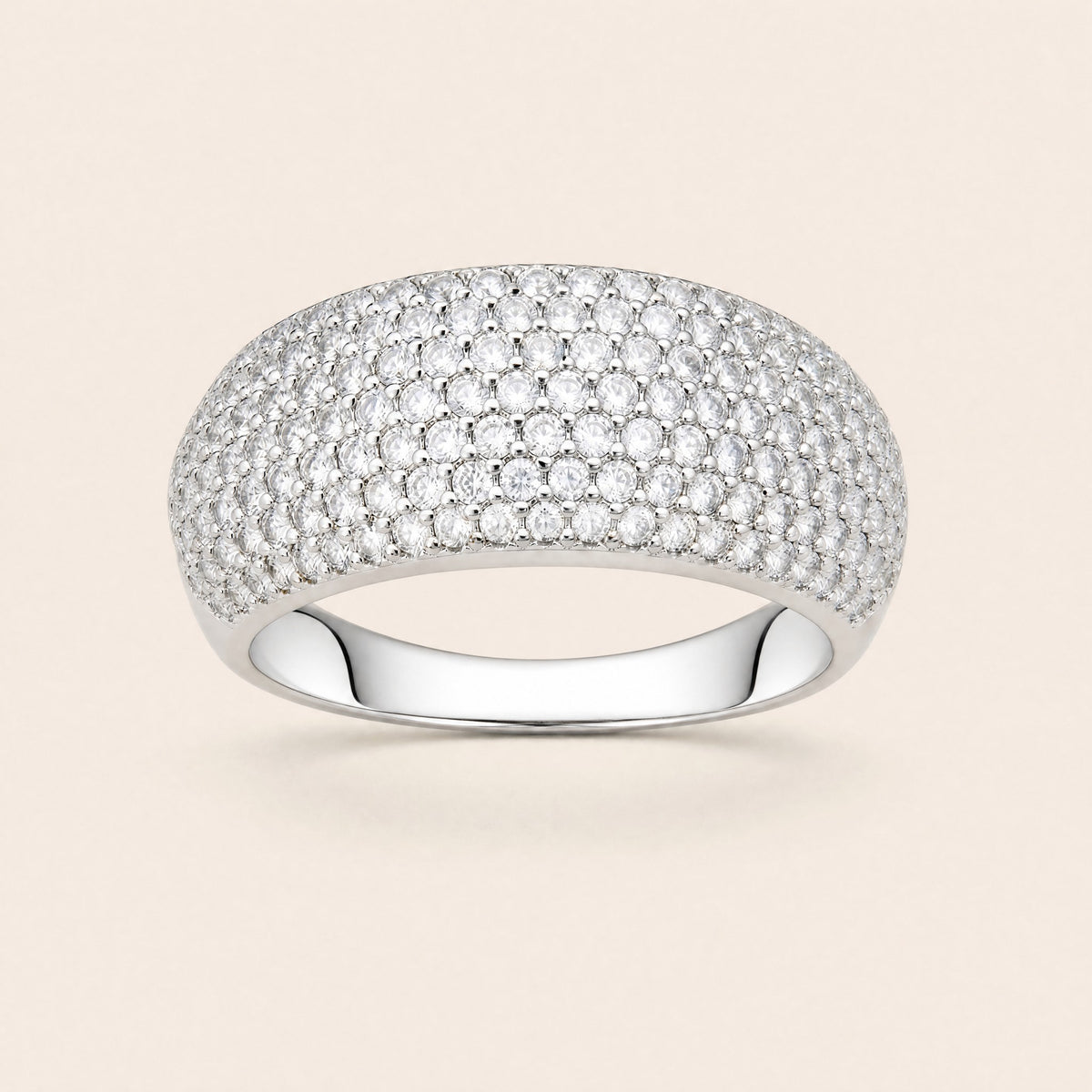 Pavé dome ring, front view: a wide low dome of round white stones on a polished silver band
