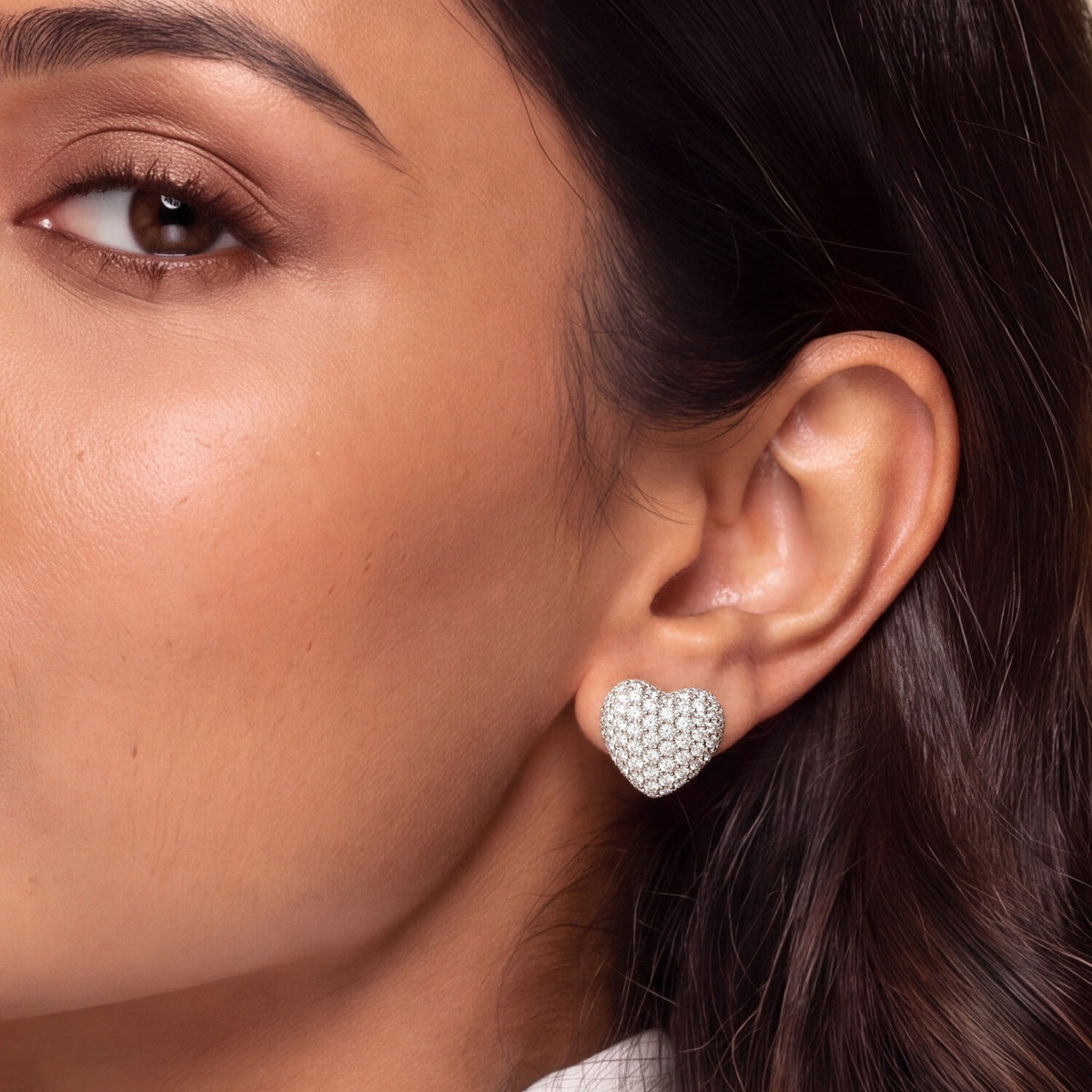 Close-up of the sterling silver pavé heart stud on the earlobe